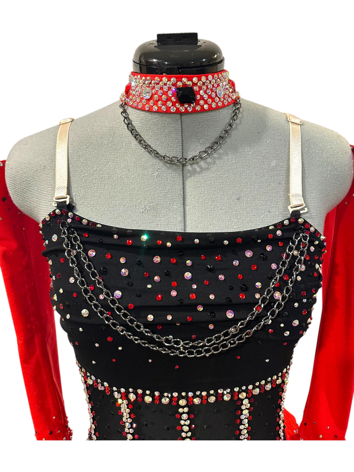 Close-up of the rhinestone bodice featuring layered chain accents, illusion mesh, adjustable straps, and a coordinating rhinestone choker.
