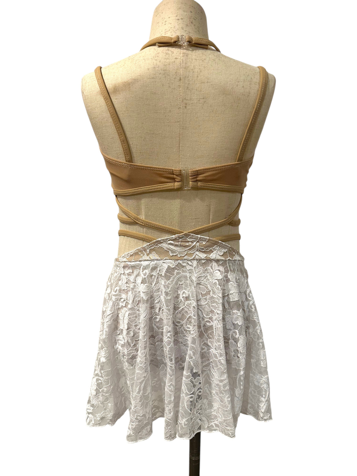 Back view of the white lace Ava dance costume base featuring crisscross straps, open back, and asymmetrical lace skirt.