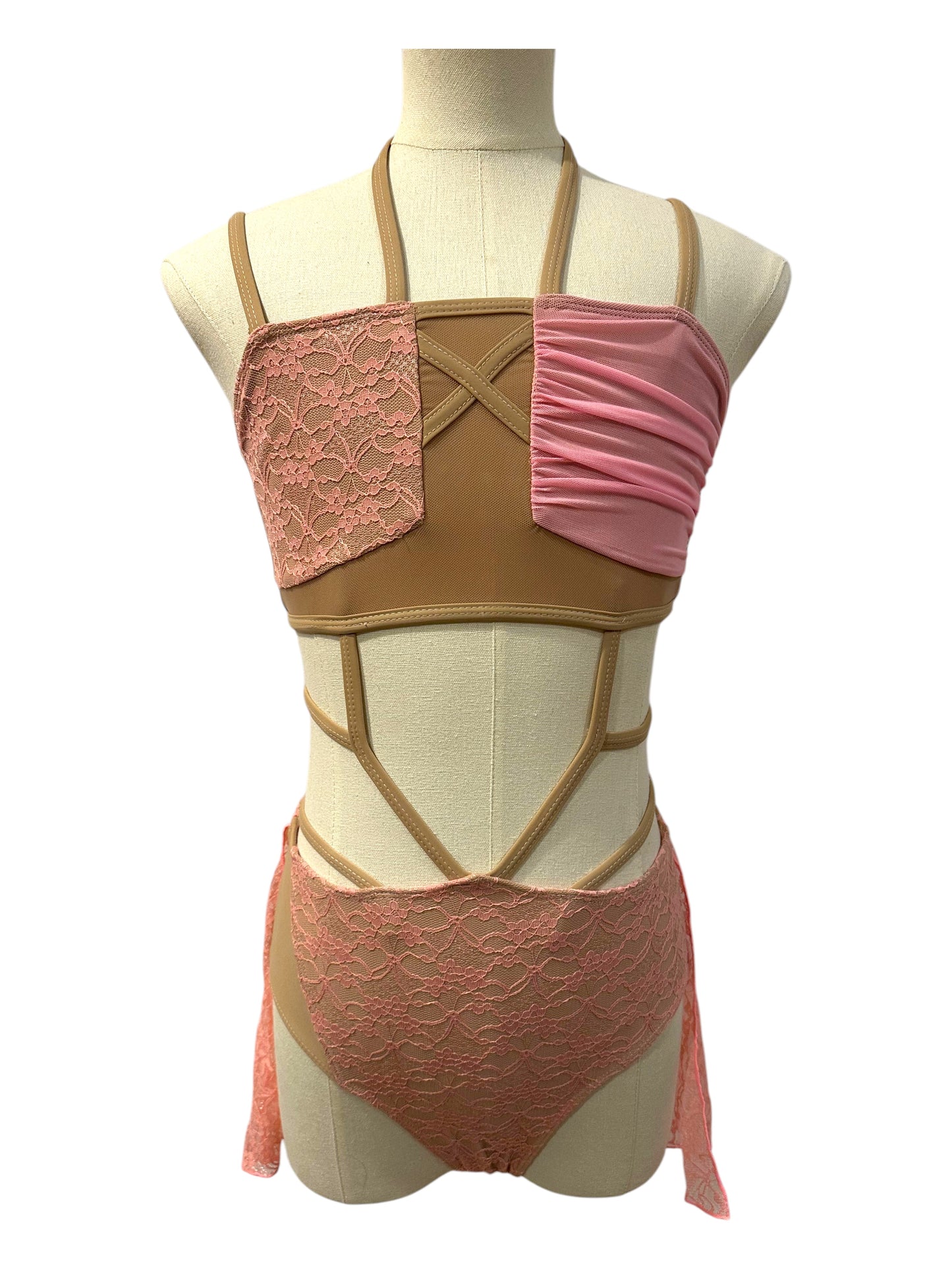 Ava dance costume base in pink with wrap-style lace bodice, nude illusion panels, and dramatic cutout competition design