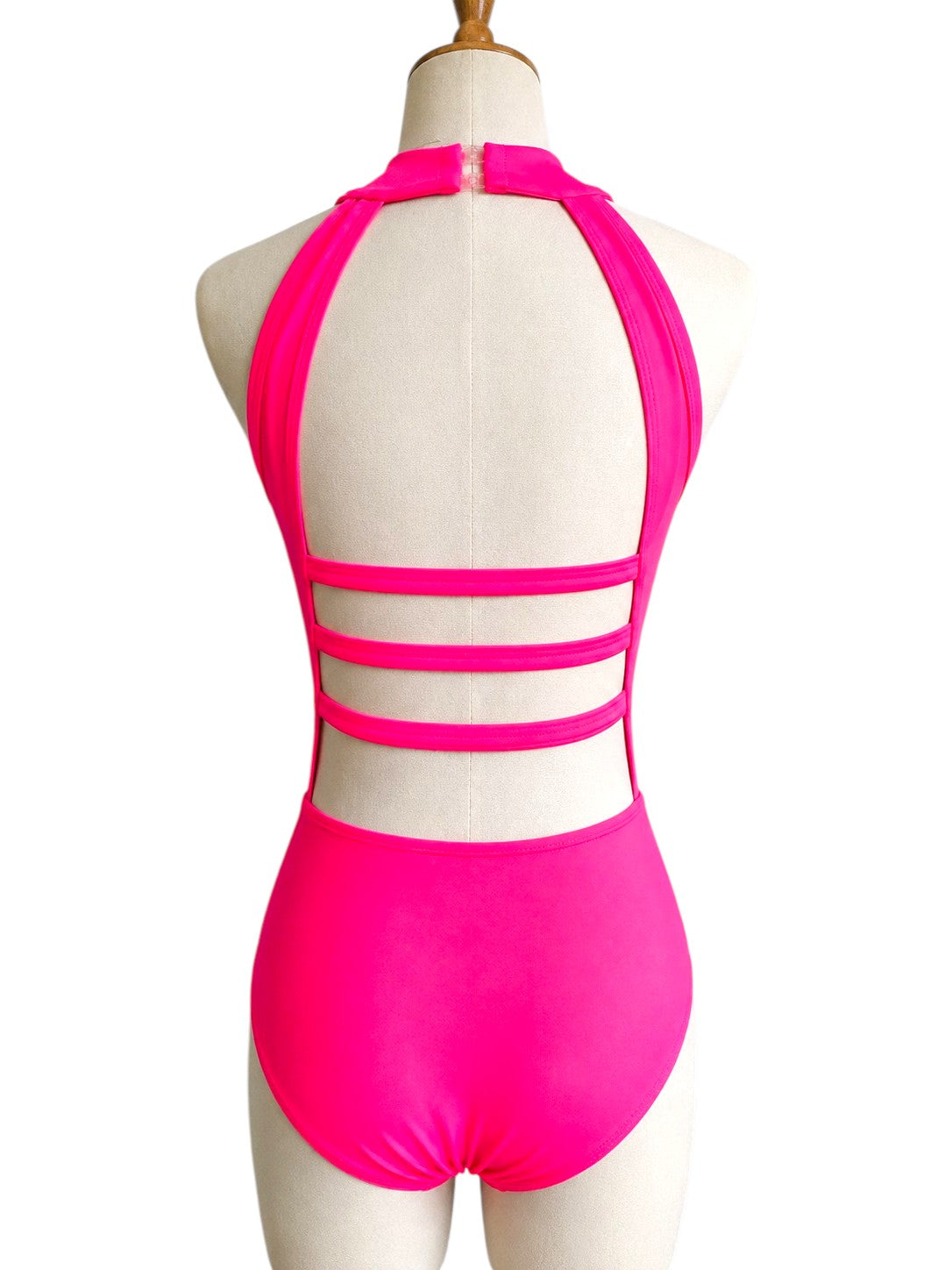 Back view of the hot pink Shanna Base Studio Collection dance costume base featuring an open back with triple horizontal straps and a halter neckline.