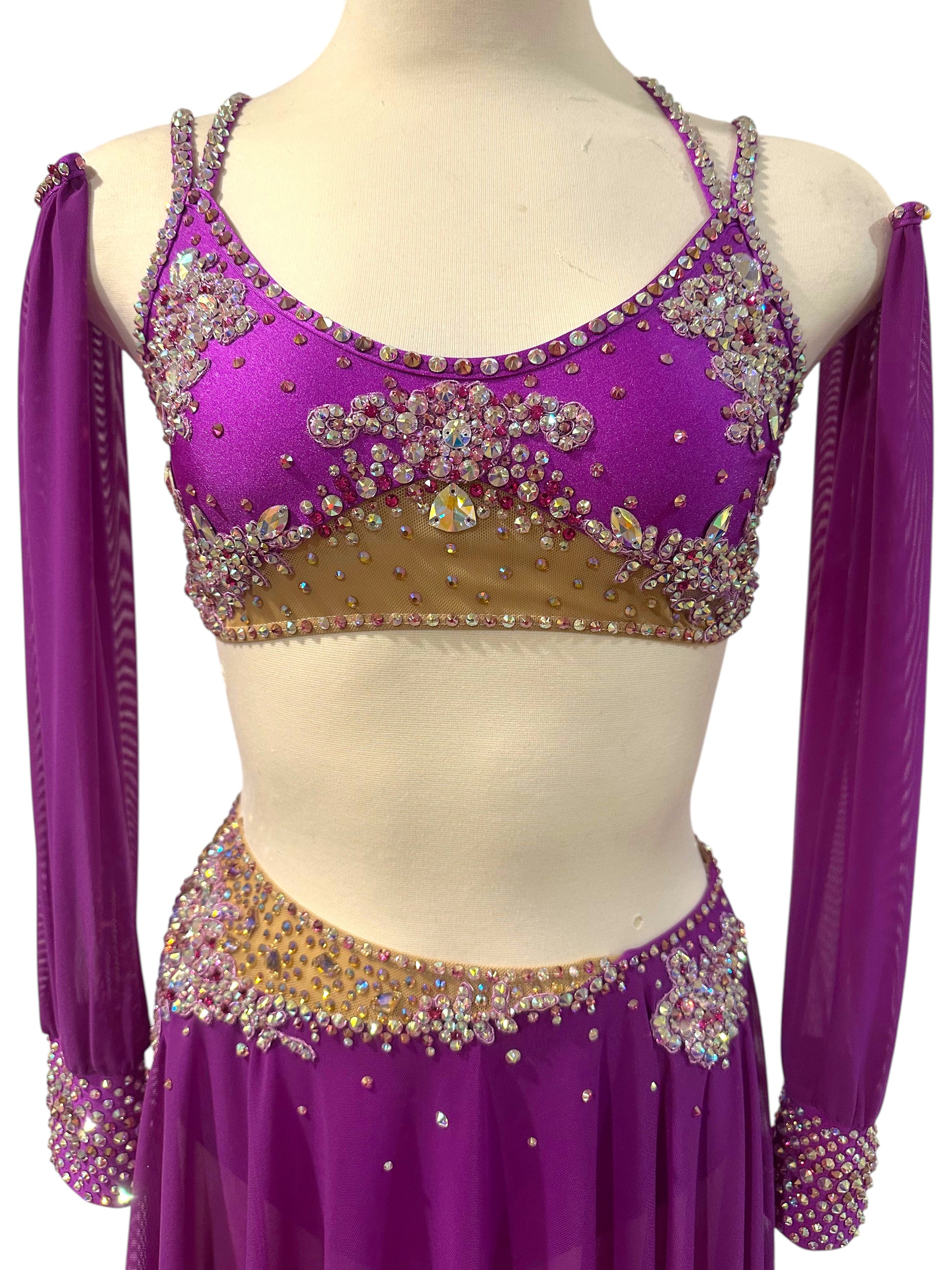 Close-up of fuchsia dance costume featuring premium AB rhinestones and nude illusion mesh.