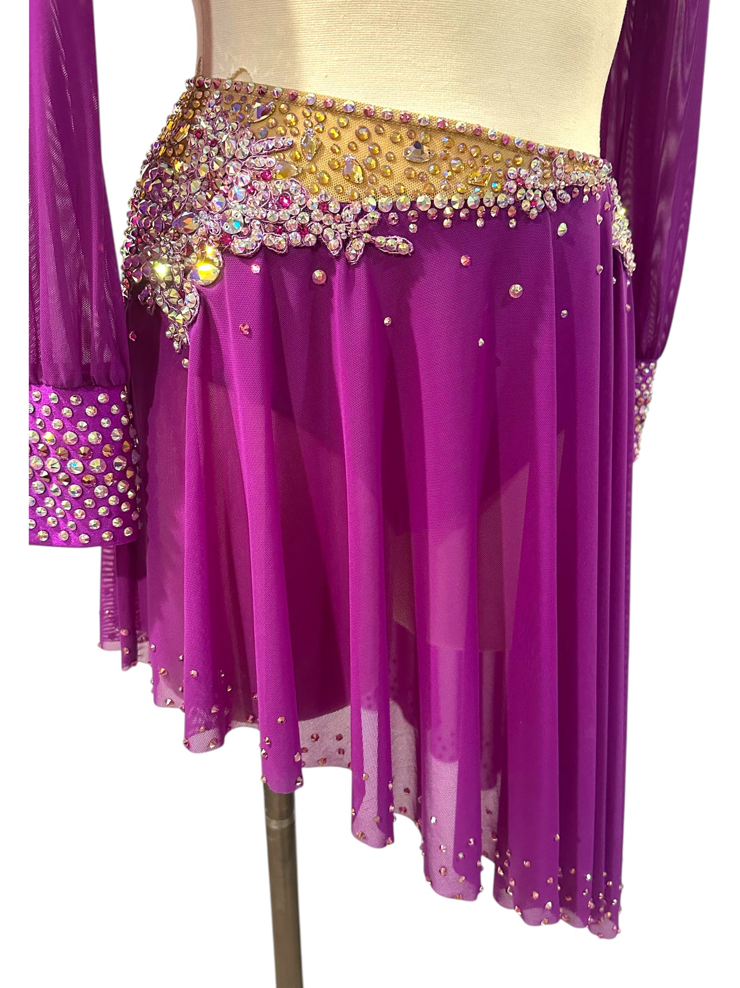 Detailed front view of the asymmetrical fuchsia mesh skirt with crystal embellished waistband.