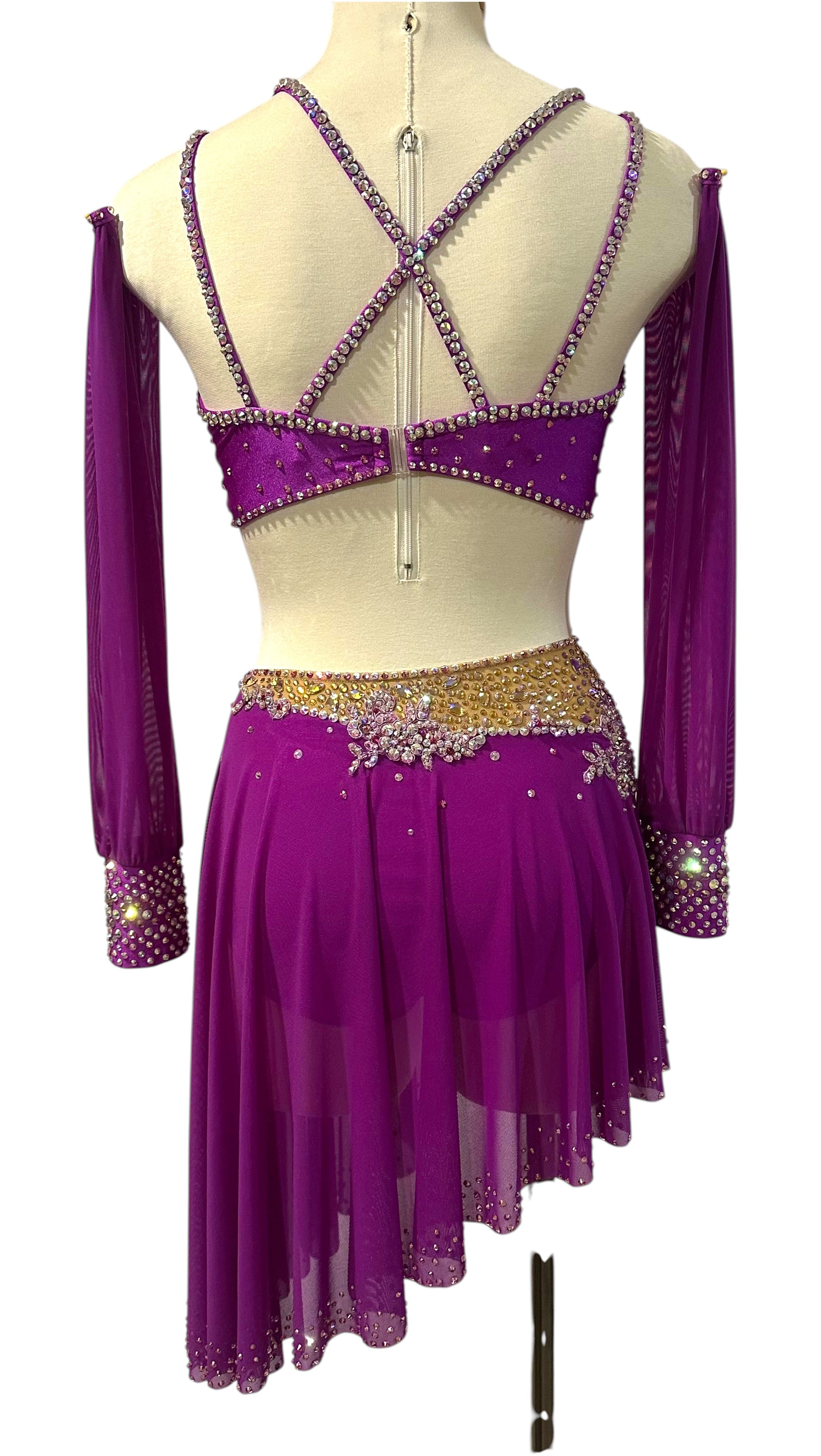 Back view of a fuchsia rhinestone dance costume featuring cross-back straps and asymmetrical mesh skirt.