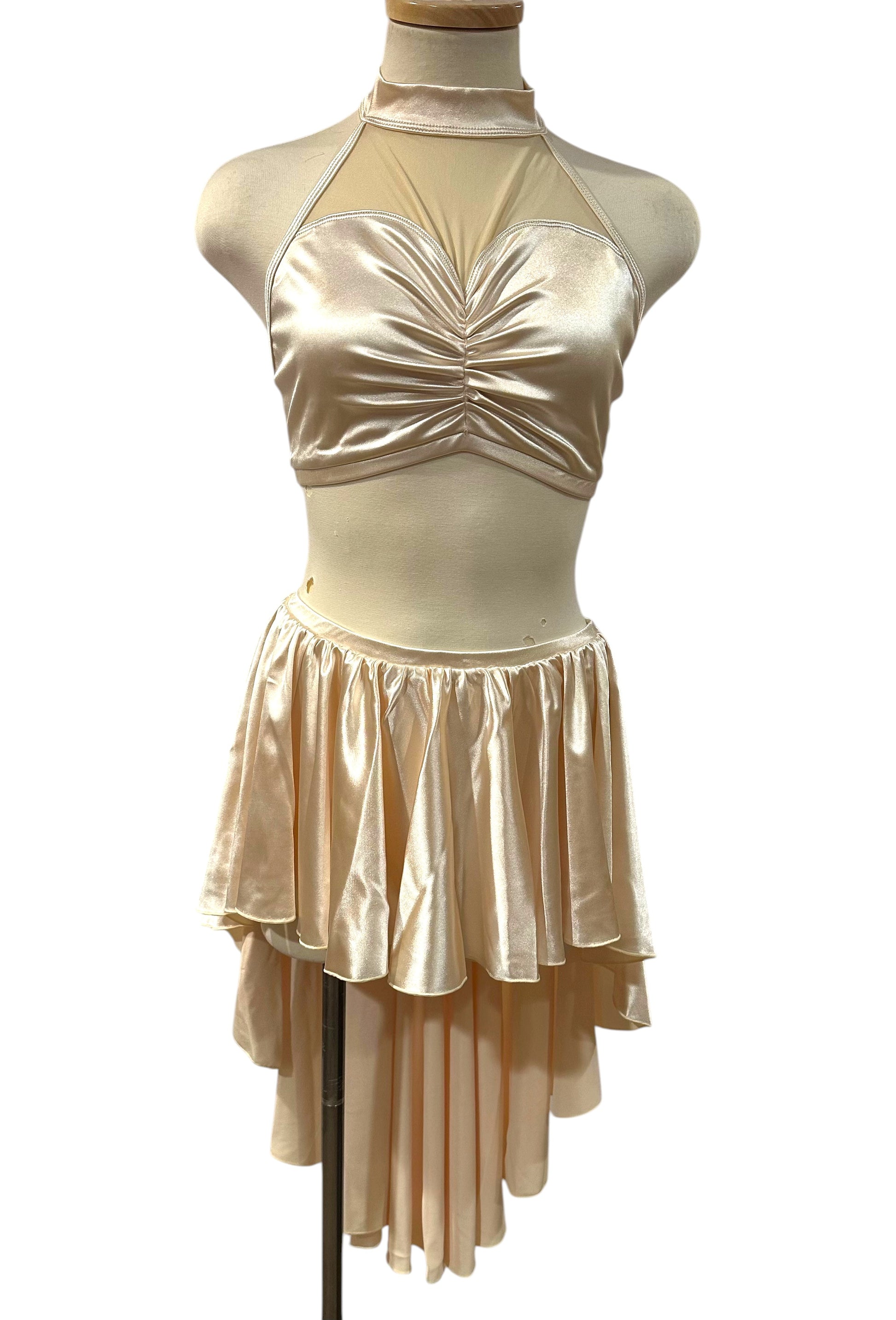 The Aubrey Base made-to-order satin dance costume featuring a mock neckline, illusion mesh bodice, and layered asymmetrical skirt.