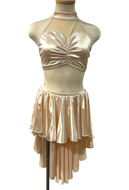 The Aubrey Base made-to-order satin dance costume featuring a mock neckline, illusion mesh bodice, and layered asymmetrical skirt.