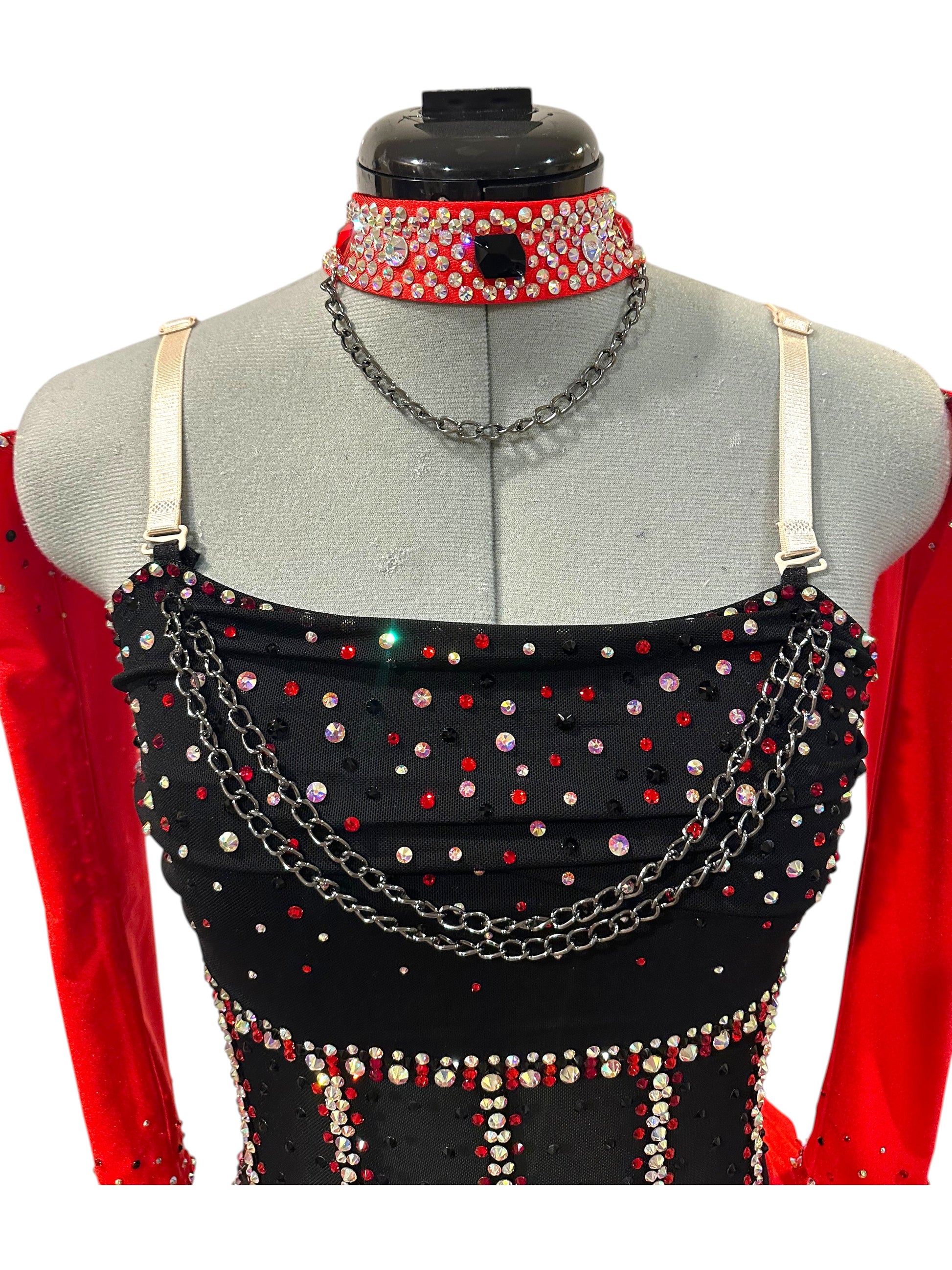 Close-up of the rhinestone bodice featuring layered chain accents, illusion mesh, adjustable straps, and a coordinating rhinestone choker.