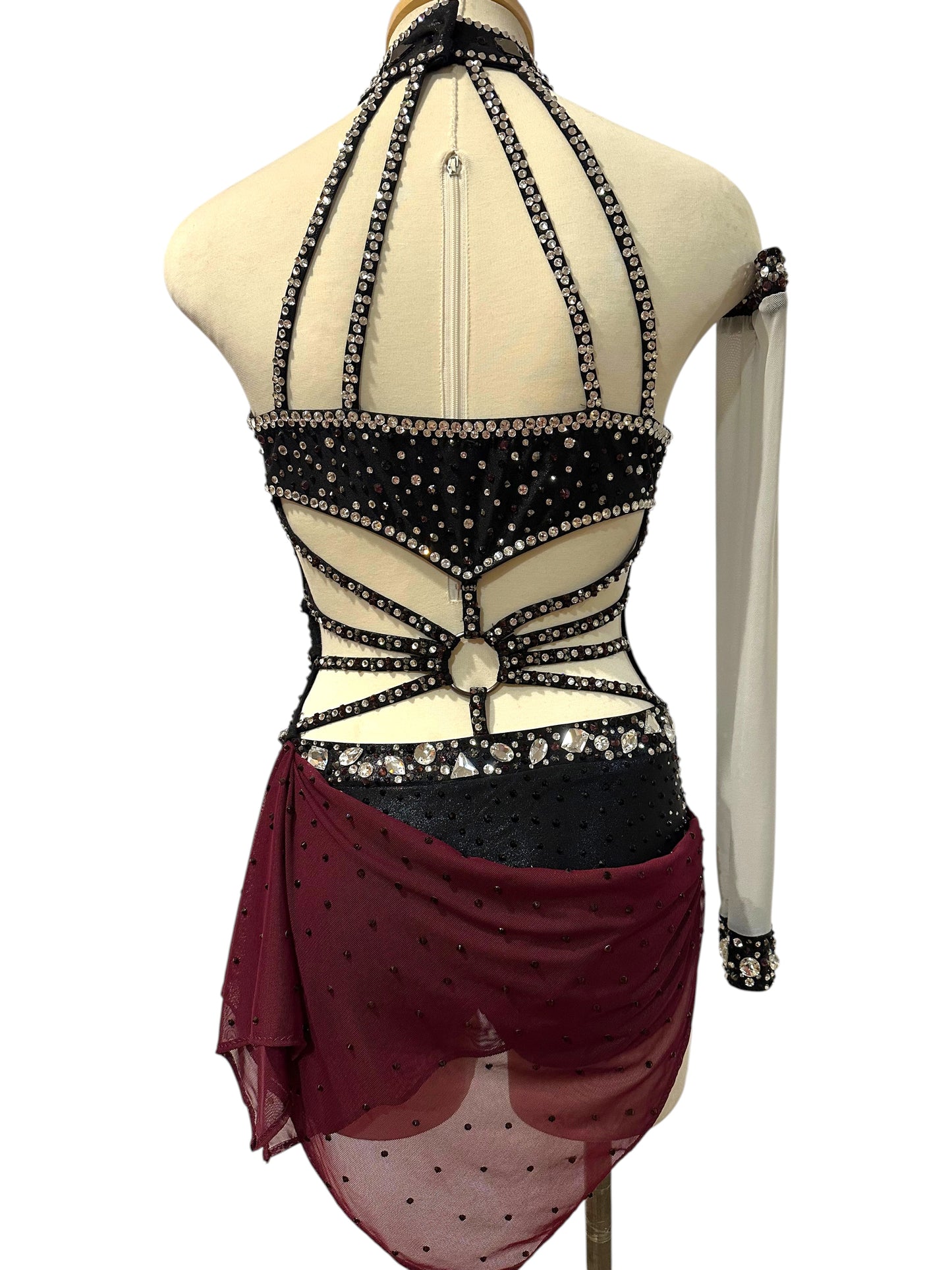 Back view of black, silver and burgundy Ready-to-Ship dance costume with open strappy back, crystal trim and asymmetrical mesh drape.