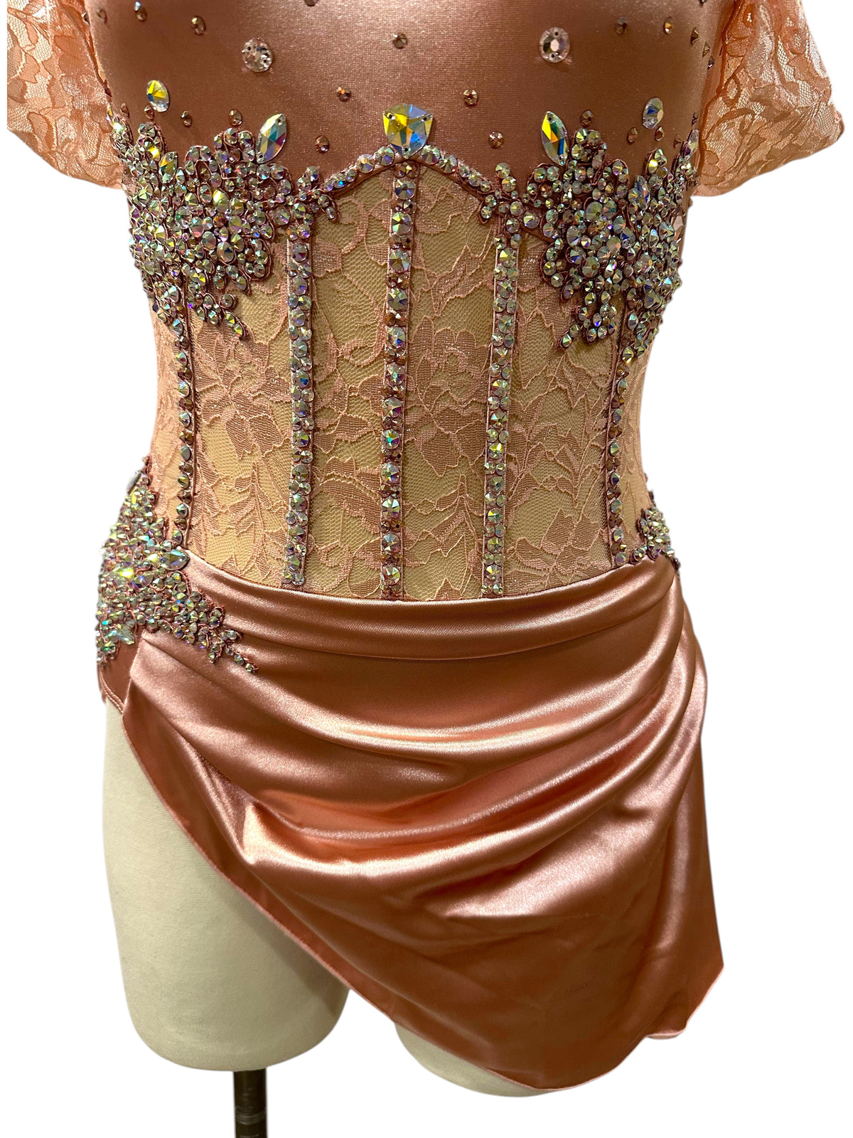 Gwendolyn Powder Rose dance costume detail showing rhinestoned floral lace corset panels and asymmetrical satin skirt