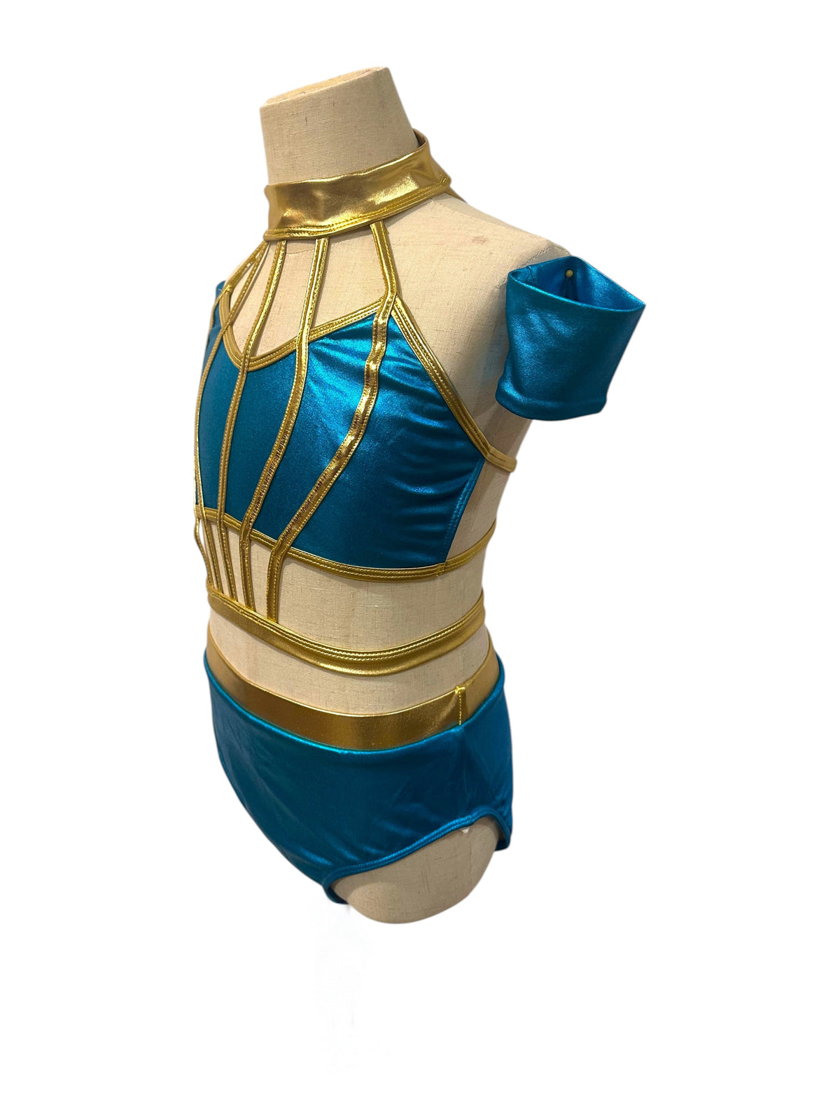 Savy River Blue and Light Gold dance costume base showing high neckline, nude illusion panels, and metallic geometric trim