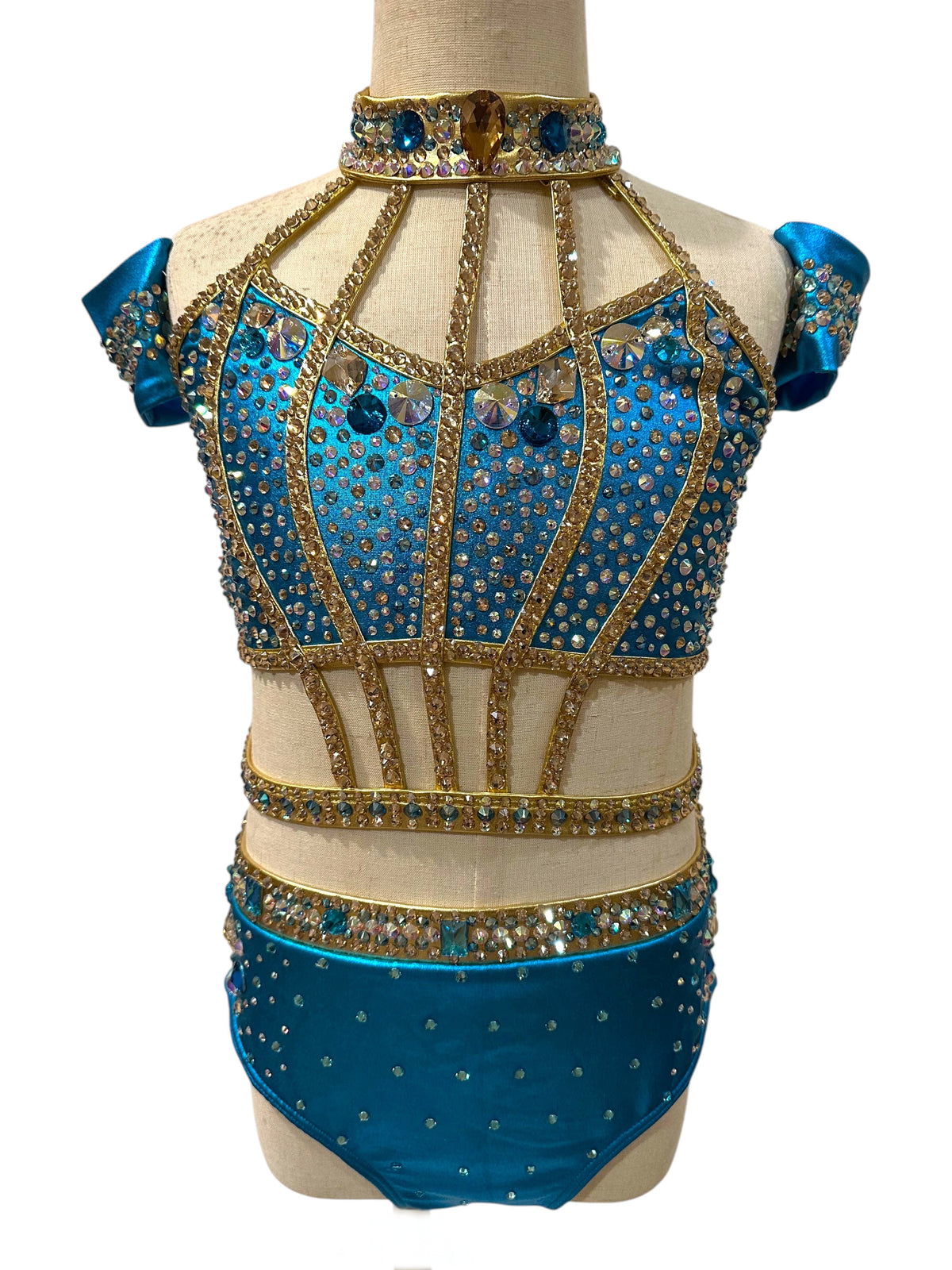 Completed Savy dance costume inspiration in Metallic River Blue and Gold with nude illusion panels, full rhinestone embellishment, high neckline, and matching arm cuffs