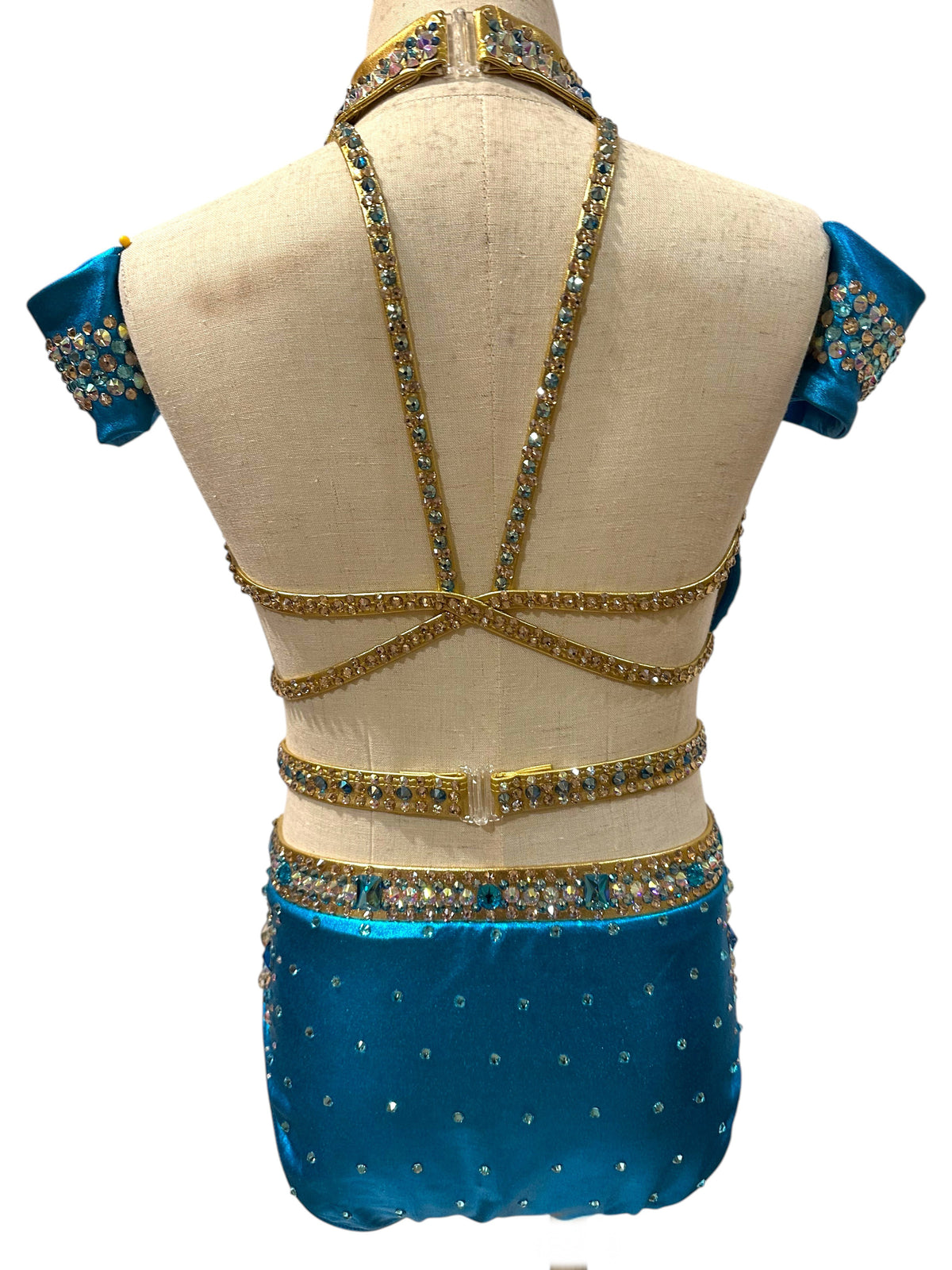 Back view of completed Savy dance costume inspiration in Metallic River Blue and Gold with open strappy back, rhinestone detailing, and matching embellished arm cuffs