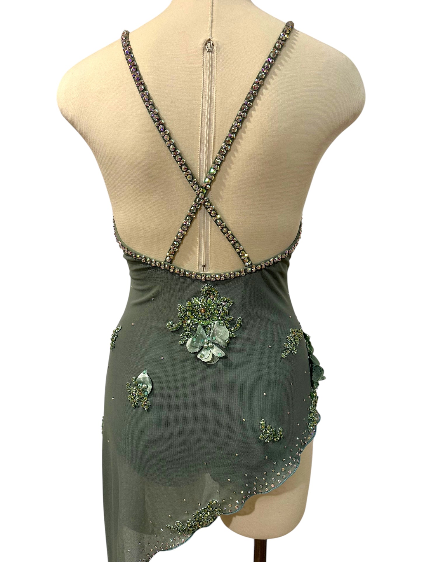 Back view of olive-green rhinestone dance costume with open-back design, crisscross straps, and asymmetrical skirt.