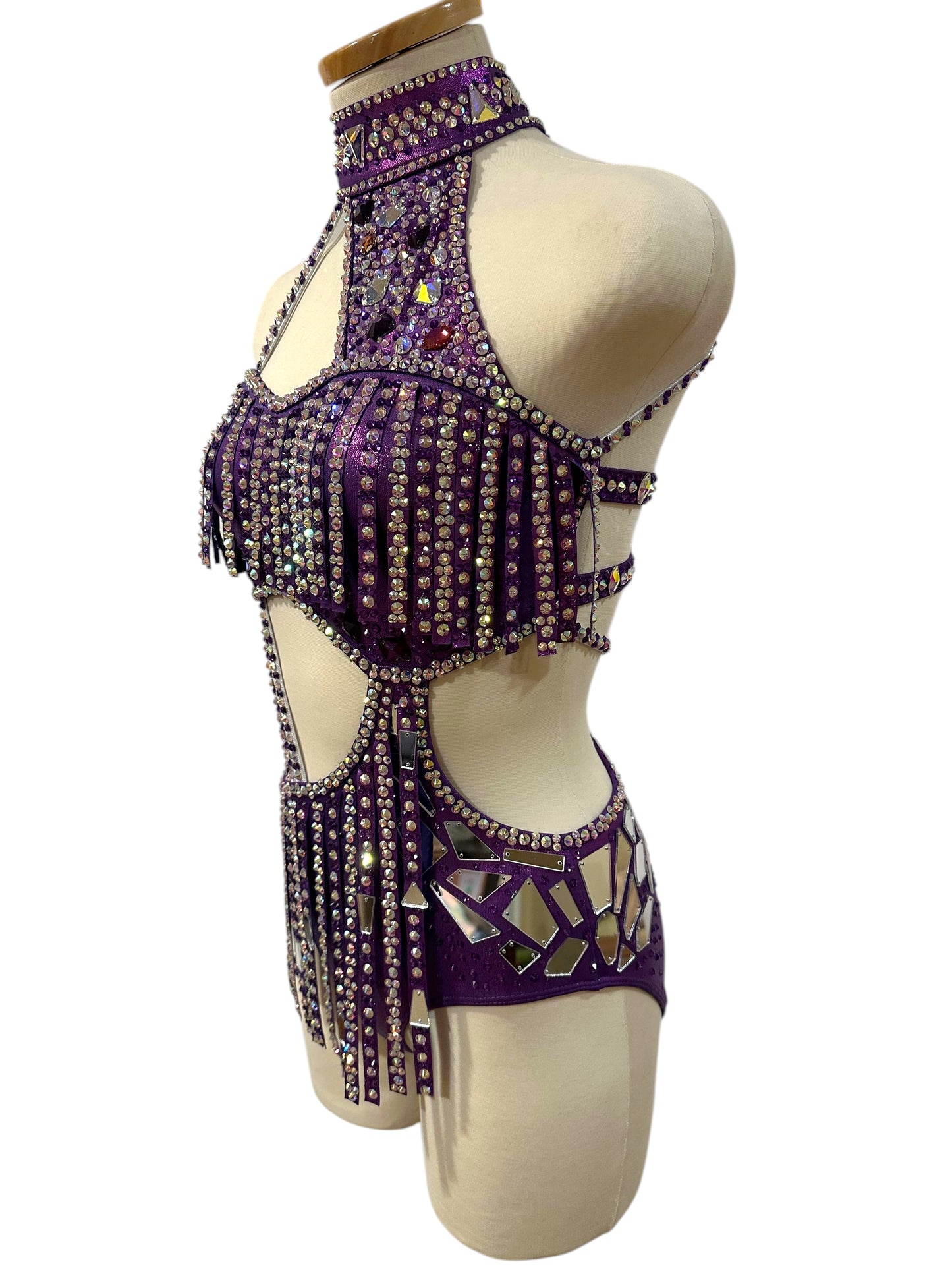 Side view of ready-to-ship hologram purple dance costume with rhinestone detailing, mirror accents, and dramatic cutout silhouette.
