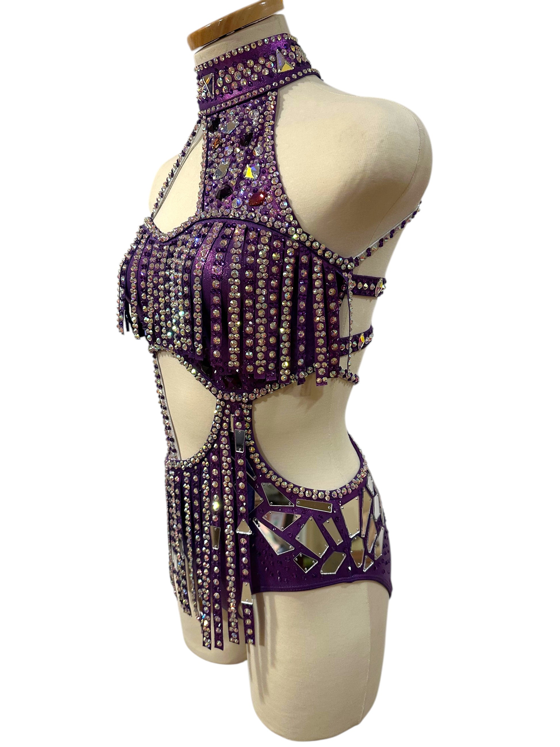 Side view of ready-to-ship hologram purple dance costume with rhinestone detailing, mirror accents, and dramatic cutout silhouette.