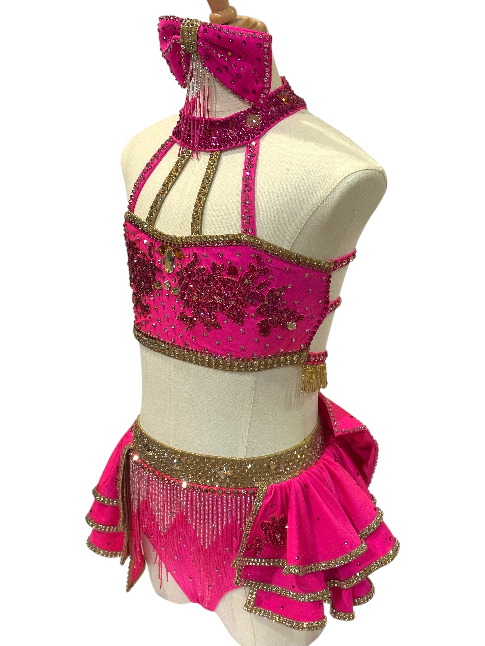 Side view of ready-to-ship hot pink dance costume with gold accents, premium rhinestones, and competition-ready design.