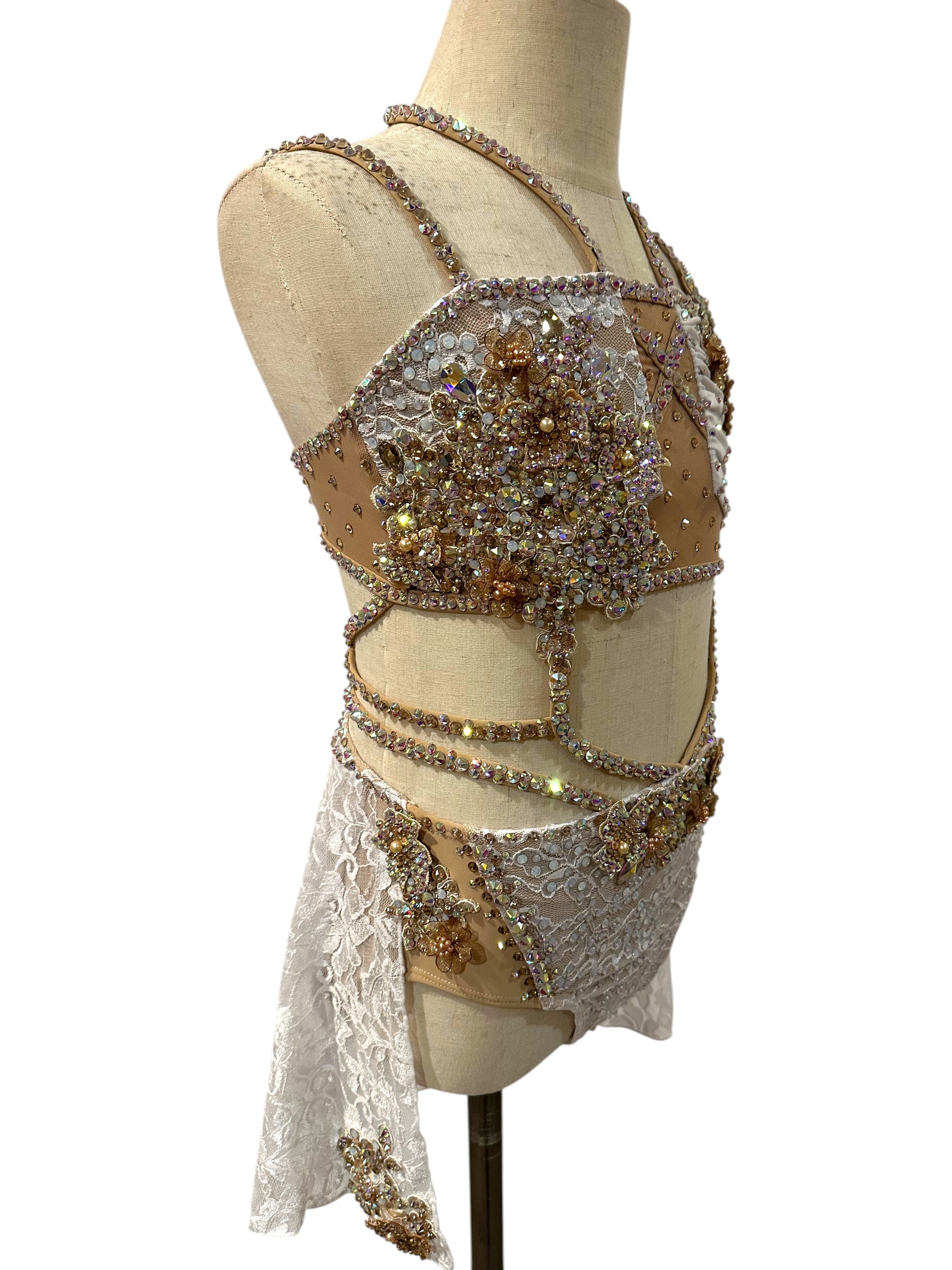 White lace dance costume side view with rhinestone embellishments and strappy detailing