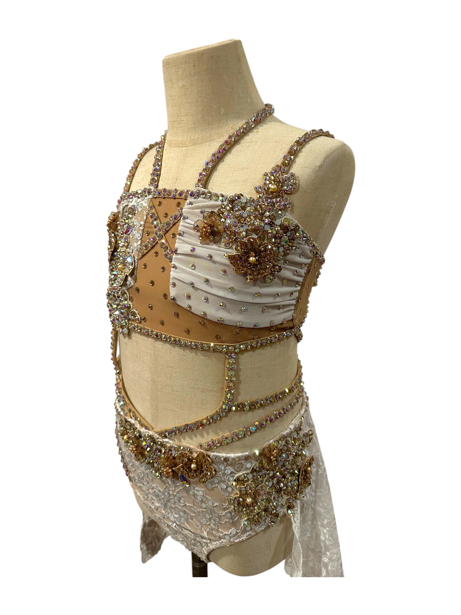 White lace competition costume angled front view with crystal appliqué
