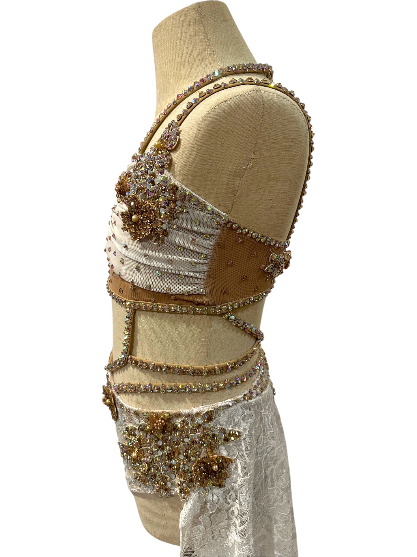White lace dance costume left side profile featuring rhinestone appliqué and mesh accents