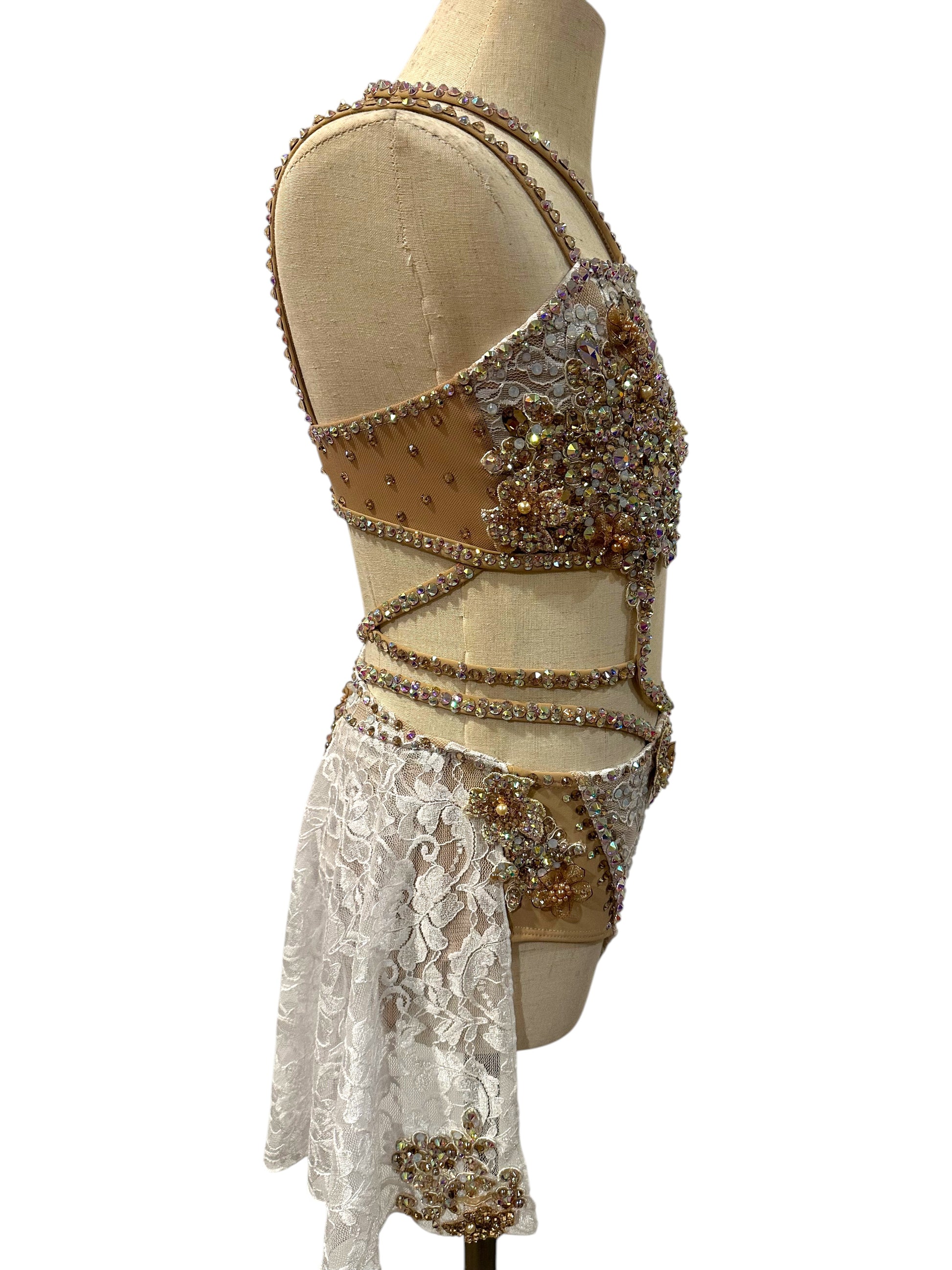 White lace dance costume right side profile featuring rhinestone appliqué and mesh accents
