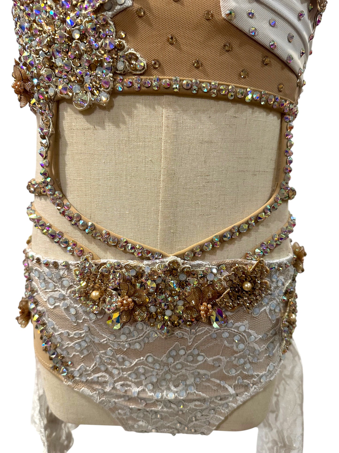 White lace dance costume waist detail with crystal embellishment and lace construction