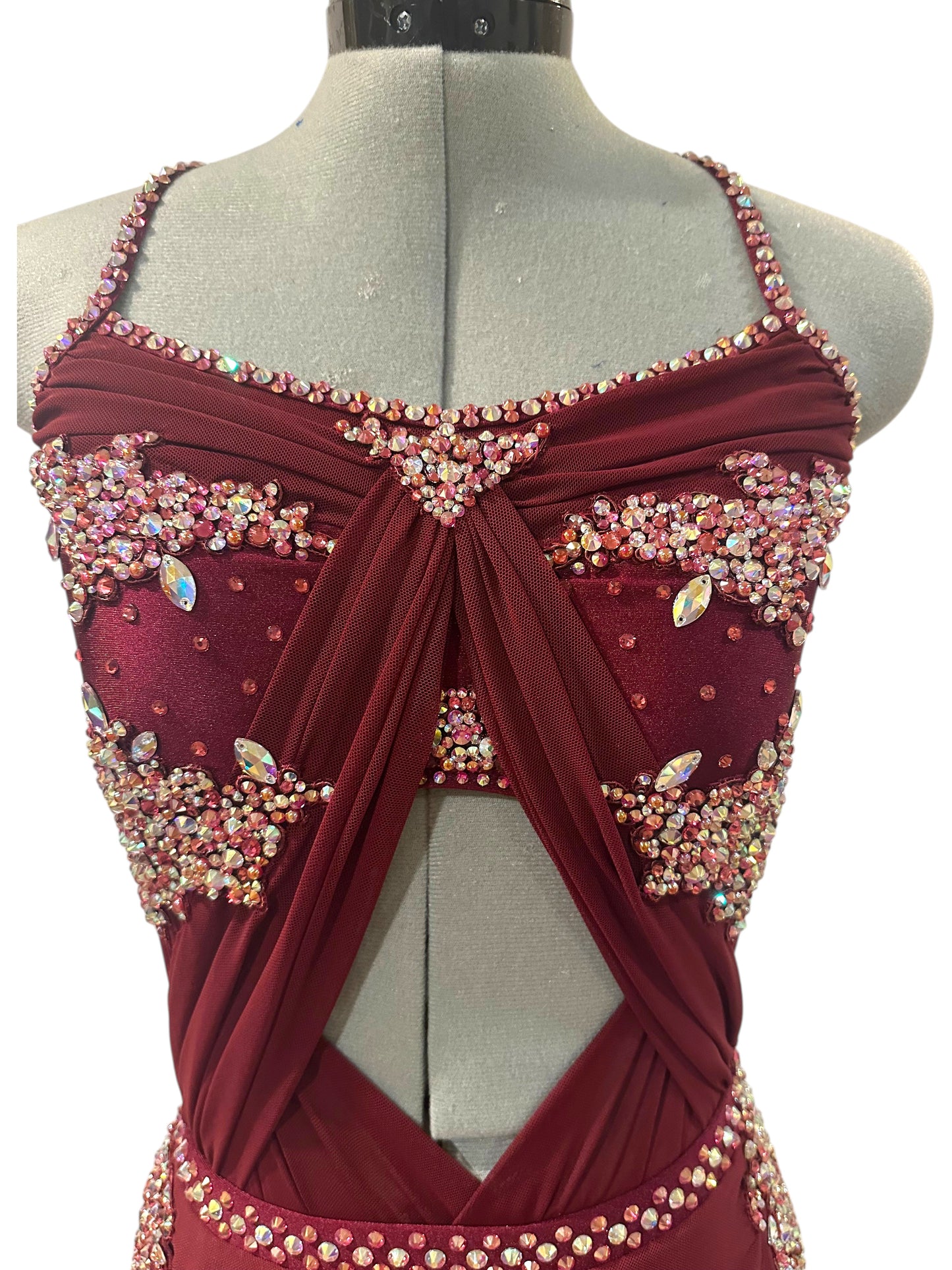 Close-up of burgundy rhinestone dance costume with crystal embellished bodice, sweetheart neckline, and front cutout detail