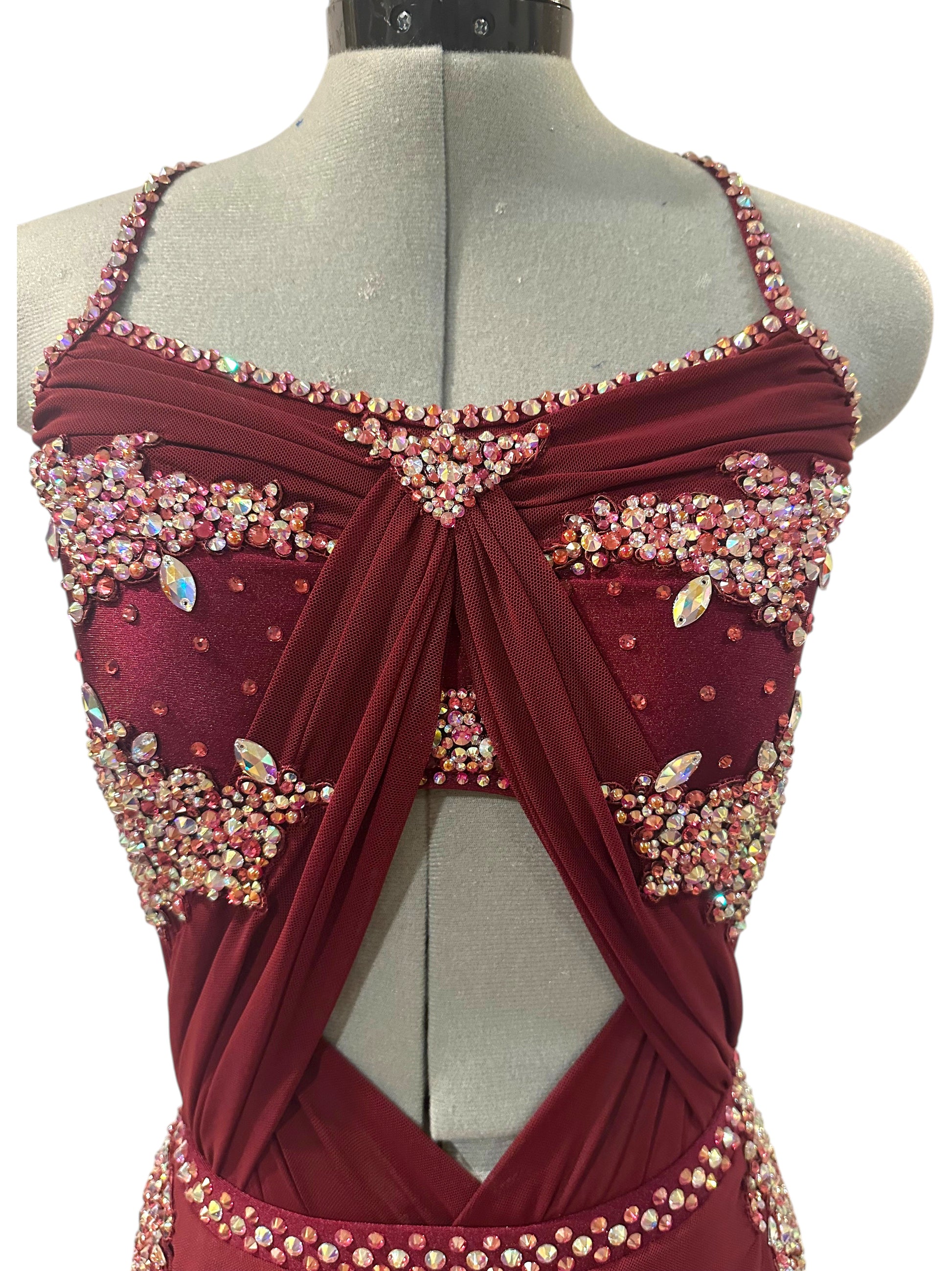Close-up of burgundy rhinestone dance costume with crystal embellished bodice, sweetheart neckline, and front cutout detail