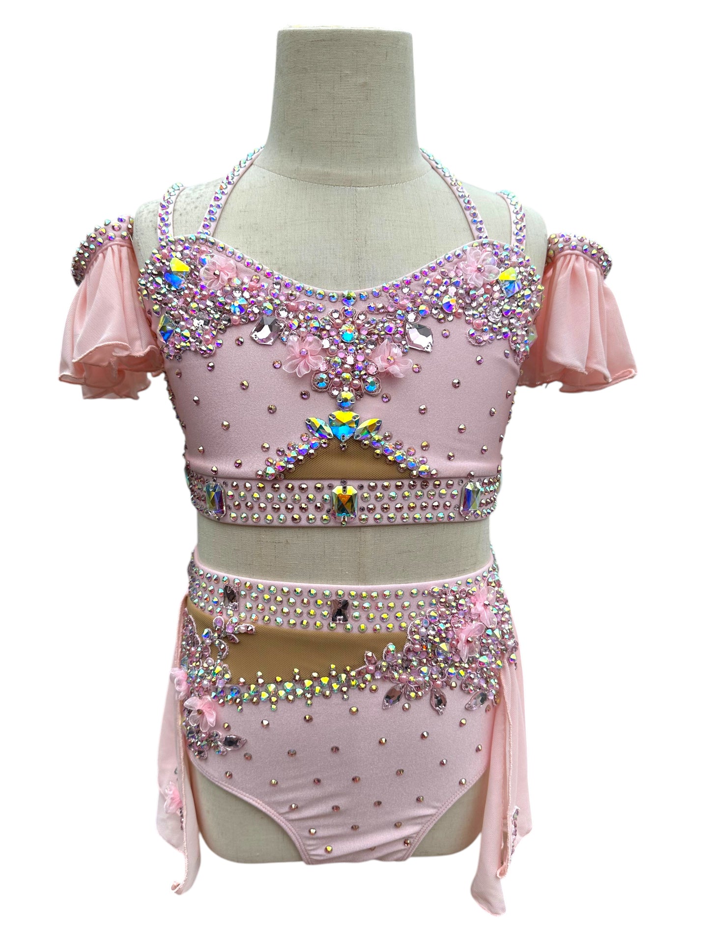 Blush pink rhinestone dance costume with floral appliqués and off-shoulder chiffon sleeves front view