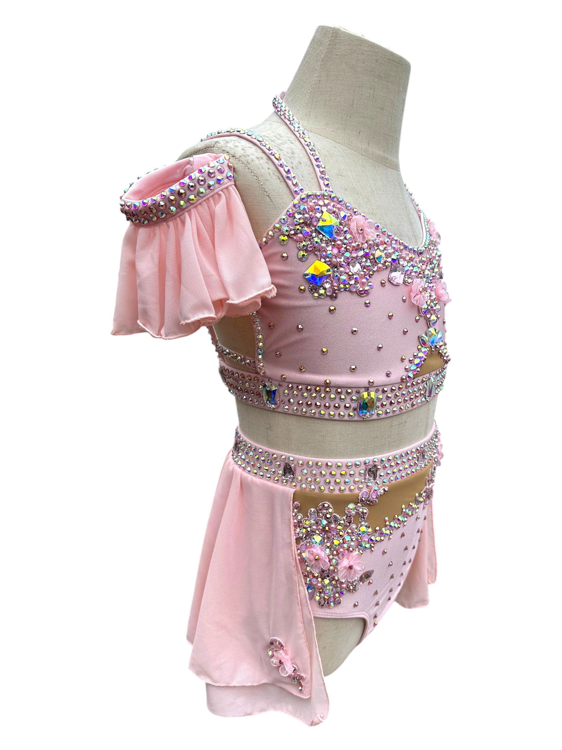 Right side view of blush pink dance costume featuring premium AB rhinestones and chiffon sleeves