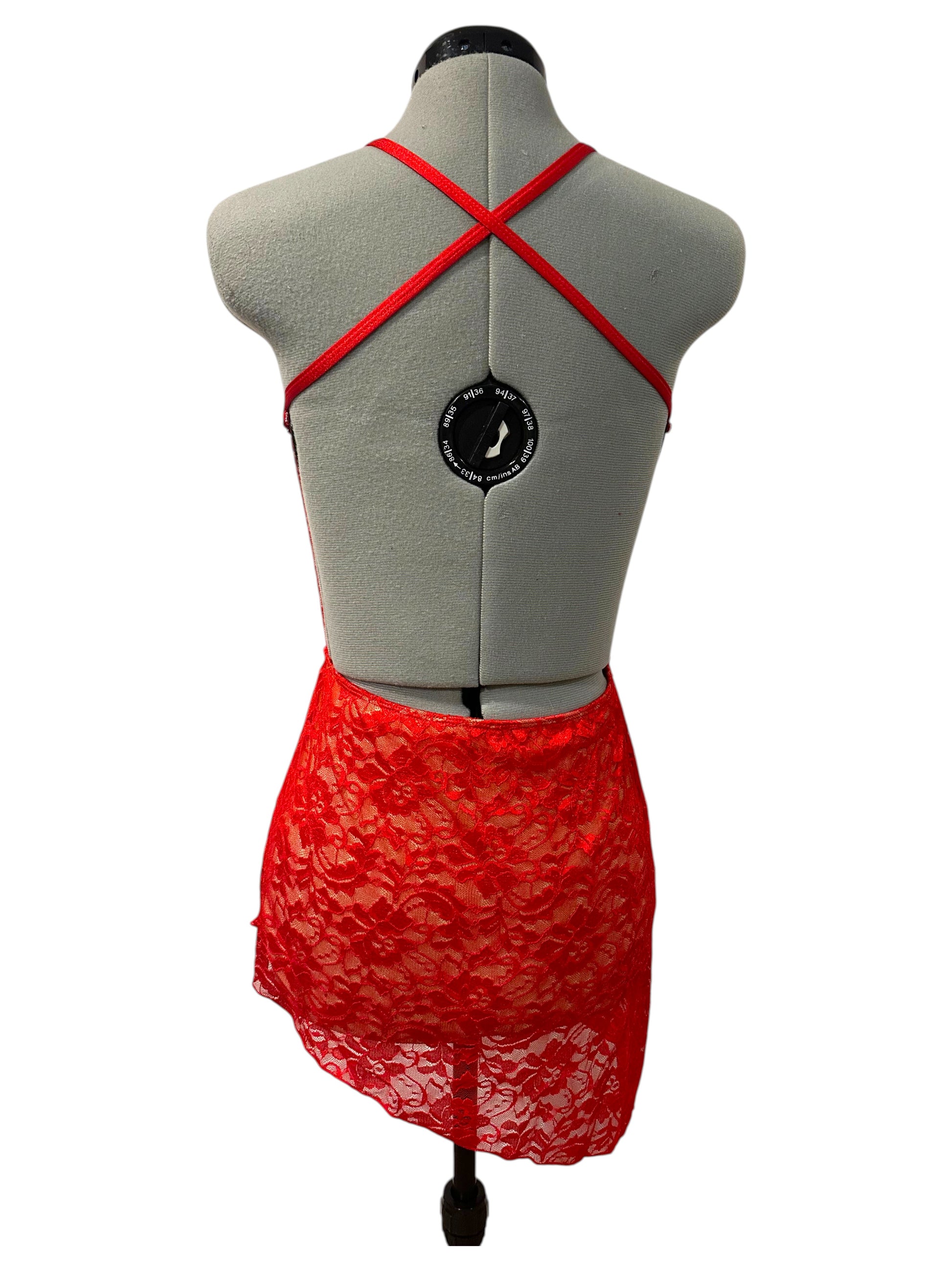 Amber Base competition dance costume back view featuring open-back styling with crossed straps and red emerald lace fabric