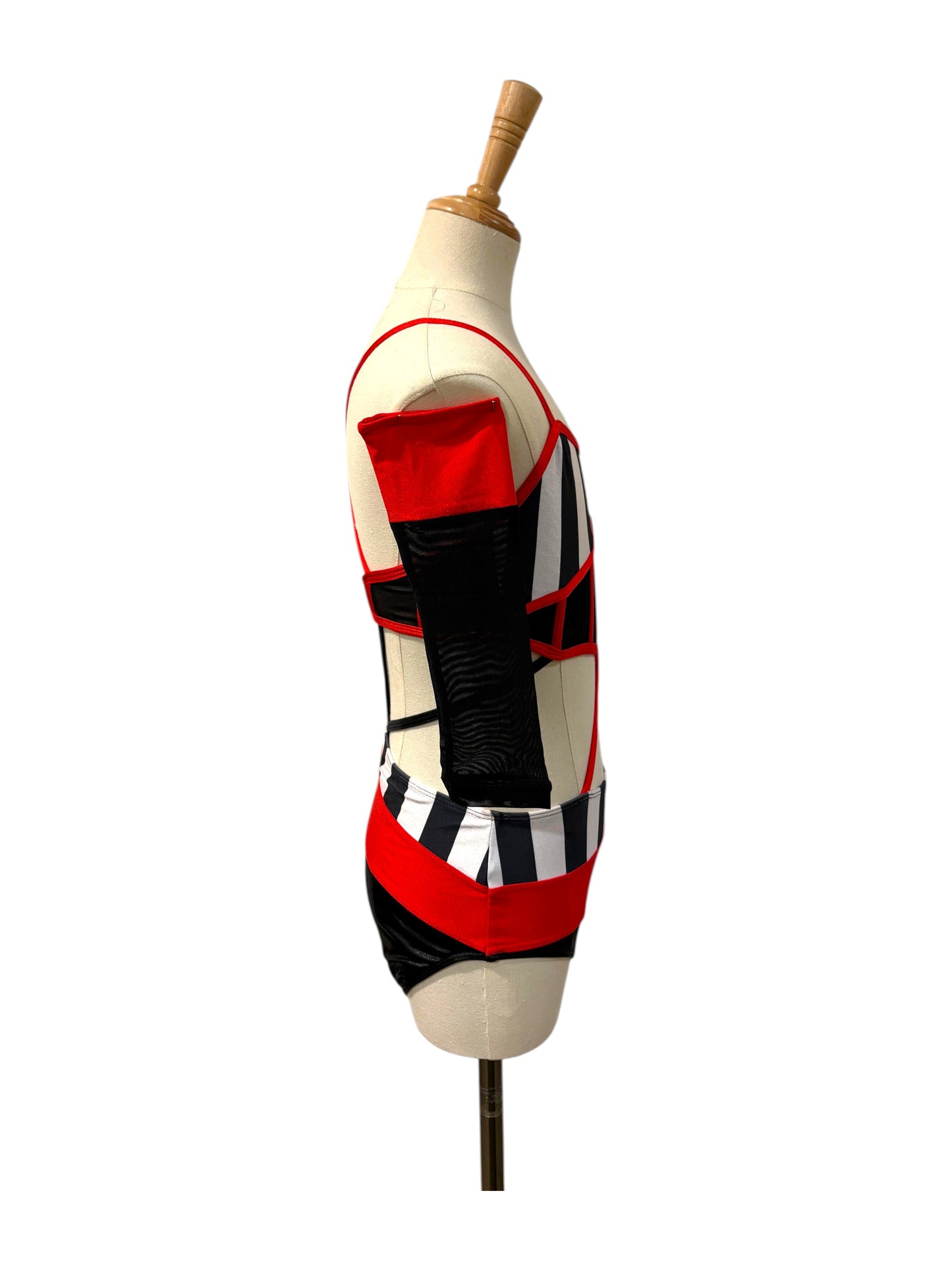 Right side view of the Kat Base competition dance costume highlighting illusion mesh panels, striped bodice, and modern cutout styling.