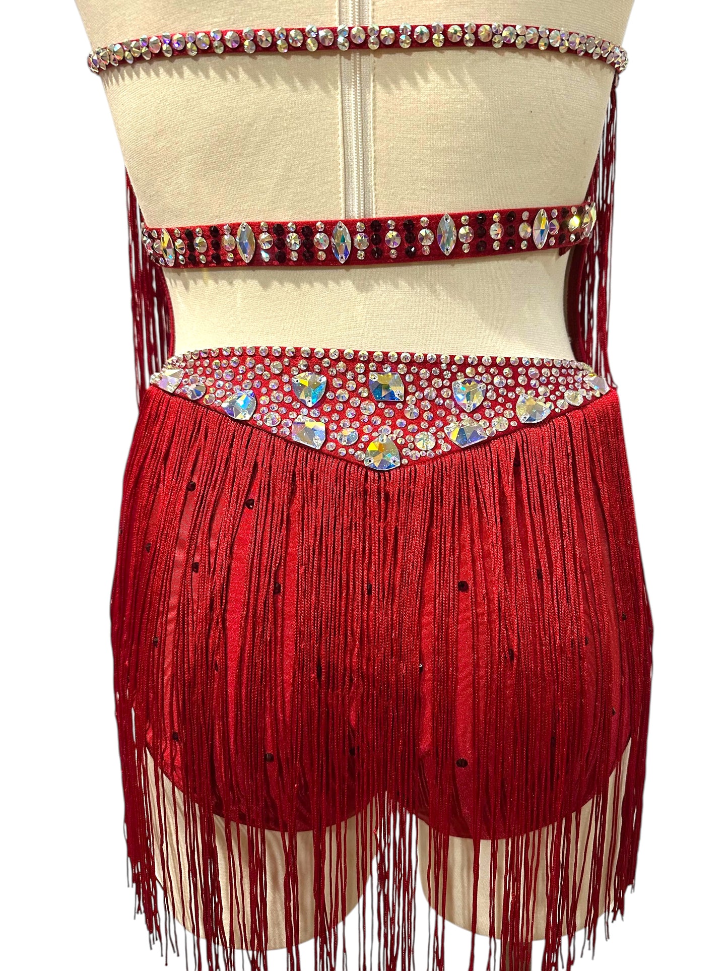 Close-up of red dance costume open back with crystal straps, rhinestone waistband, AB statement stones, and layered fringe.