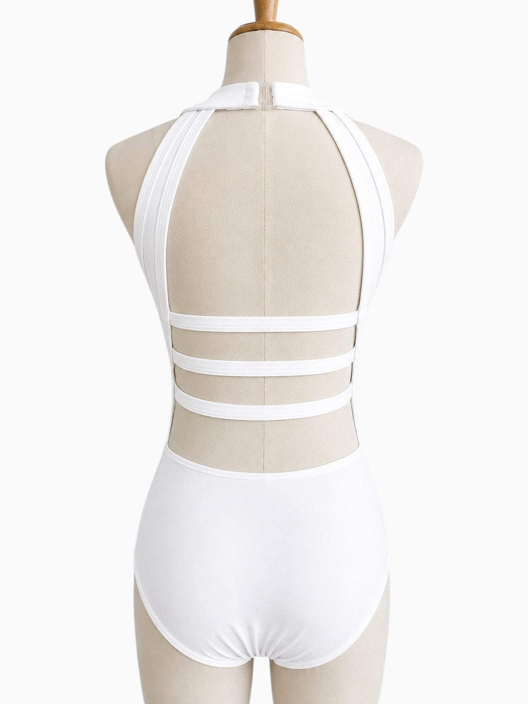 Back view of the white Shanna Base Studio Collection dance costume base featuring an open back with triple horizontal straps and a halter neckline.